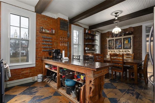 interior space with brick wall, beam ceiling, and a healthy amount of sunlight