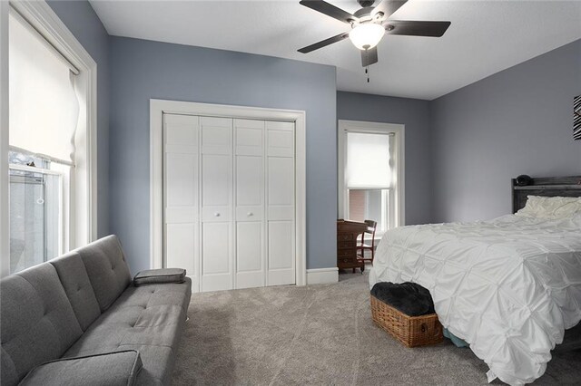 carpeted bedroom featuring a closet and a ceiling fan