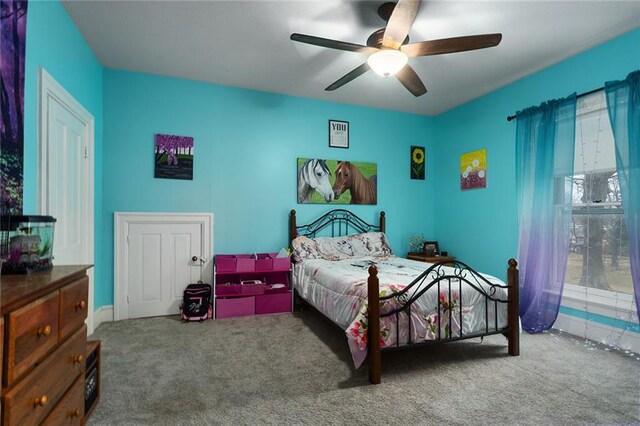 carpeted bedroom with a ceiling fan