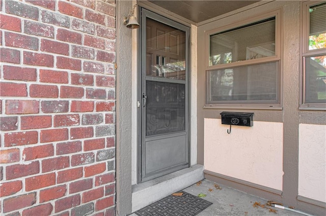 property entrance featuring brick siding