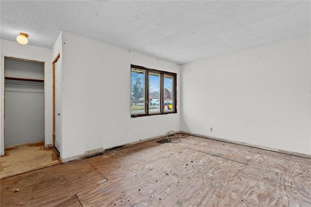 unfurnished bedroom with a closet and a textured ceiling