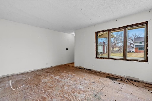 spare room with a textured ceiling