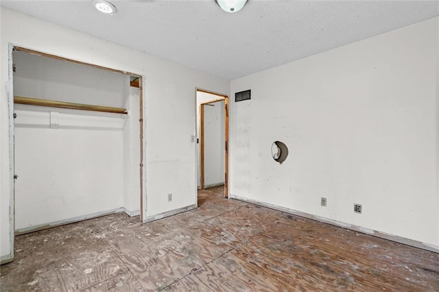 unfurnished bedroom featuring a closet and a textured ceiling