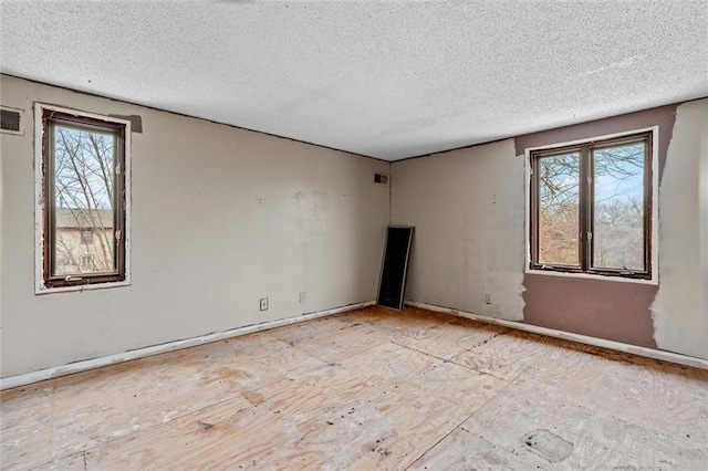 spare room featuring visible vents and a textured ceiling