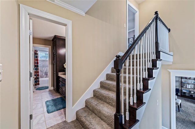 staircase featuring baseboards and tile patterned flooring