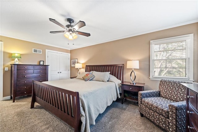 bedroom featuring visible vents, ornamental molding, a closet, carpet, and baseboards