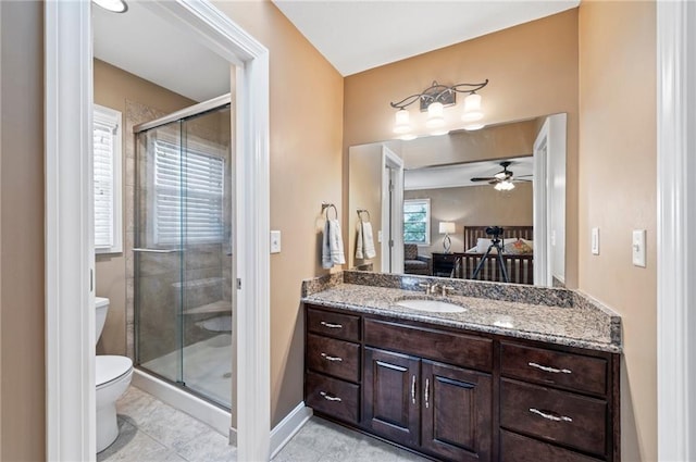 ensuite bathroom with connected bathroom, a stall shower, toilet, and vanity