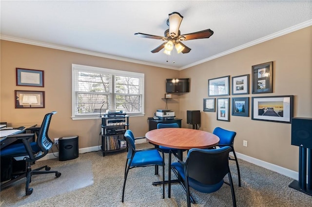 office space with baseboards, a ceiling fan, carpet, and ornamental molding