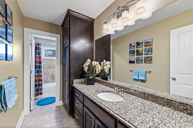 full bath with vanity, shower / bath combo with shower curtain, and baseboards