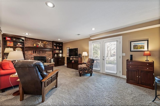 carpeted living room with baseboards, recessed lighting, french doors, crown molding, and a brick fireplace