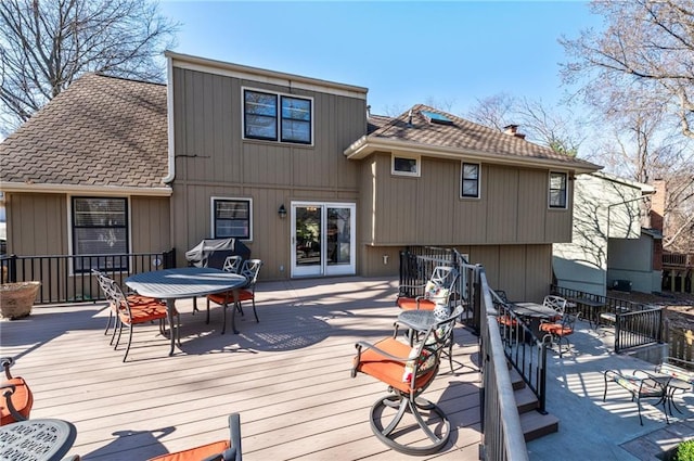 back of house featuring outdoor dining area and a deck