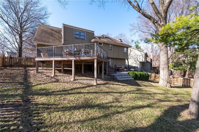 rear view of property with a wooden deck, stairway, fence private yard, and a yard