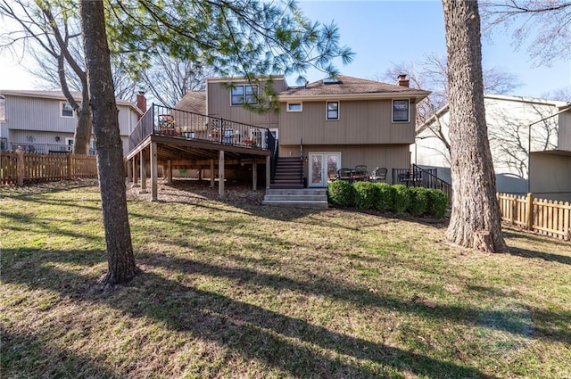 rear view of property featuring a deck, stairs, fence, and a yard