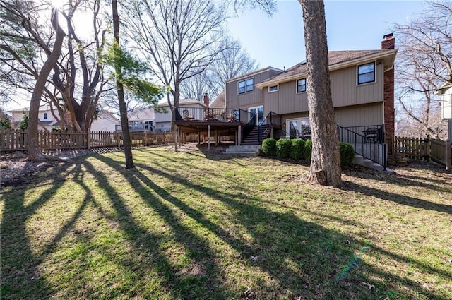 view of yard with stairs, a deck, a fenced backyard, and a residential view