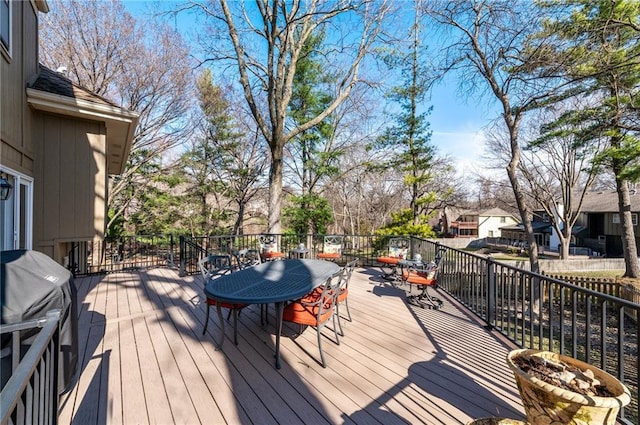 wooden deck featuring outdoor dining area