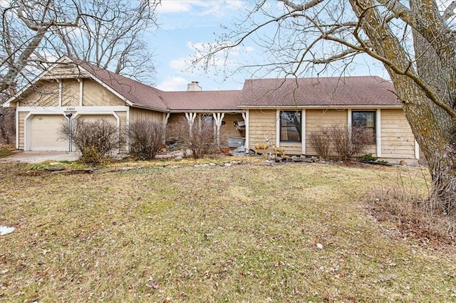 ranch-style home with a garage, a chimney, and a front lawn