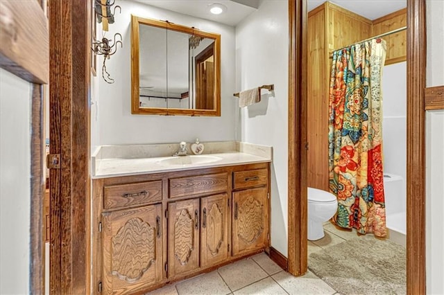 full bathroom with toilet, vanity, and tile patterned floors