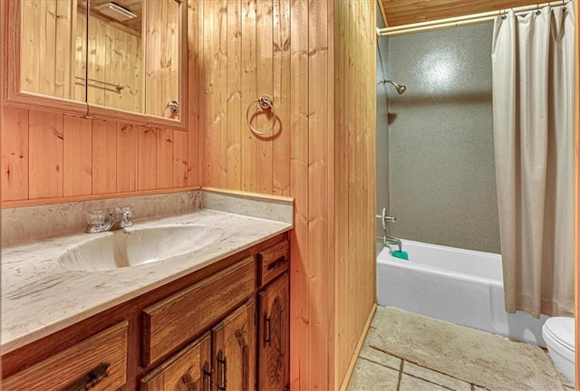 bathroom with toilet, wood walls, vanity, tile patterned floors, and shower / tub combo with curtain