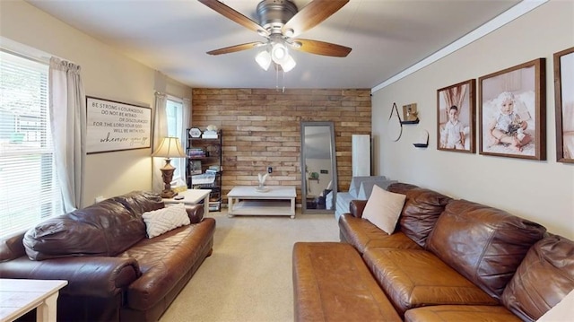 living area featuring light carpet, a ceiling fan, and brick wall