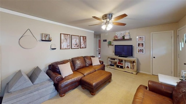 living area with baseboards, ceiling fan, and light carpet