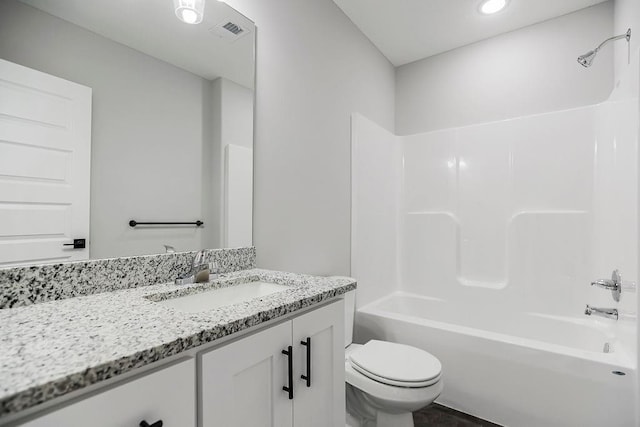 bathroom featuring visible vents, shower / bathing tub combination, vanity, and toilet