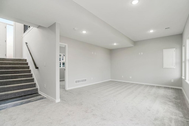 below grade area with stairway, baseboards, visible vents, and recessed lighting