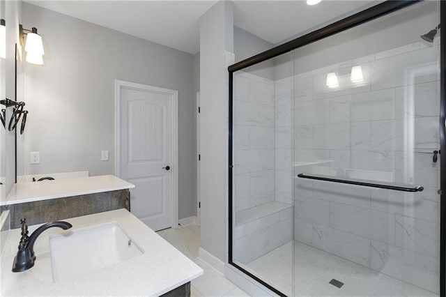 bathroom featuring a stall shower, marble finish floor, vanity, and baseboards