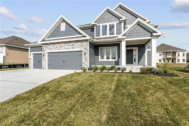 craftsman house featuring concrete driveway, a front lawn, an attached garage, and stone siding