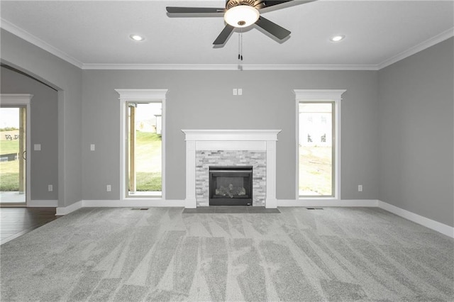 unfurnished living room with carpet floors, baseboards, a fireplace, and ornamental molding