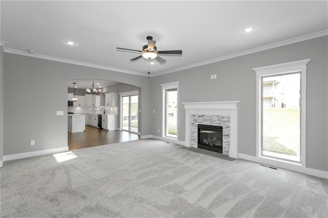 unfurnished living room with a fireplace, baseboards, dark colored carpet, and ornamental molding