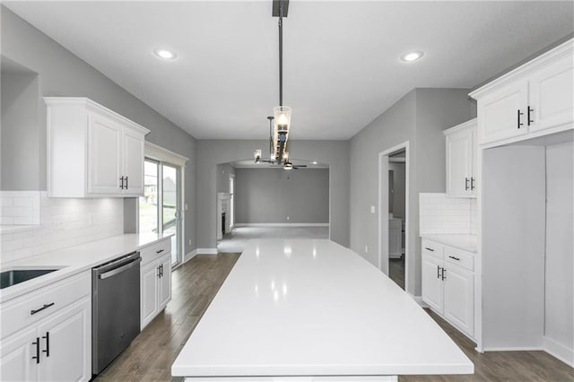 kitchen with dishwasher, light countertops, dark wood-style flooring, and white cabinetry