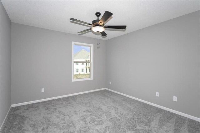 unfurnished room with ceiling fan, carpet flooring, and baseboards