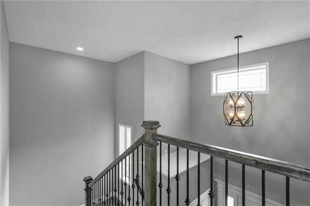 stairway with an inviting chandelier