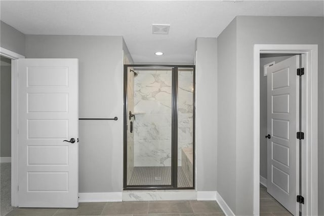 full bathroom with recessed lighting, a marble finish shower, tile patterned flooring, and baseboards