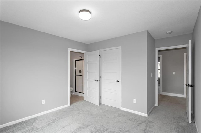 unfurnished bedroom featuring carpet floors and baseboards