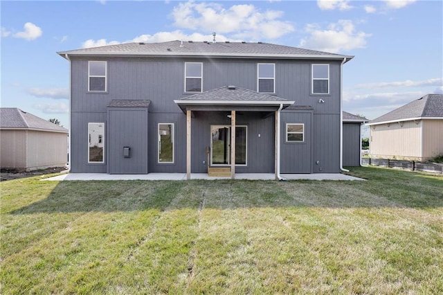 back of property featuring a patio area and a lawn