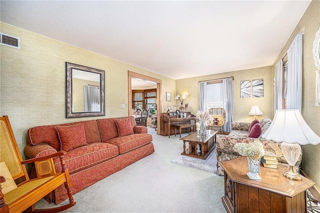 carpeted living area featuring visible vents
