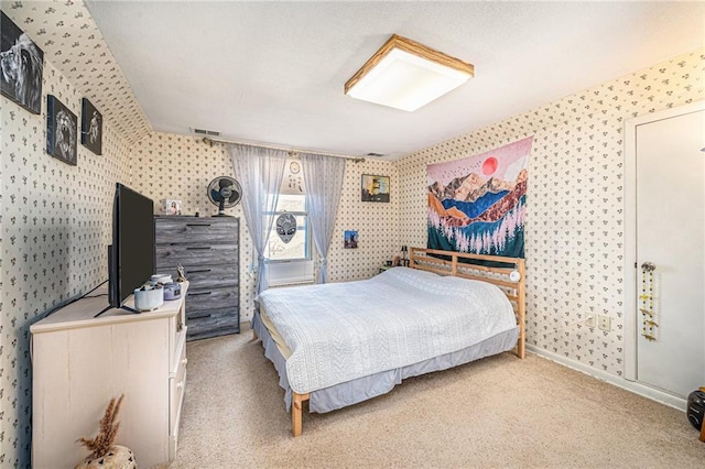 bedroom featuring baseboards, carpet, visible vents, and wallpapered walls