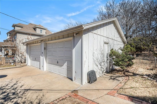 detached garage featuring fence