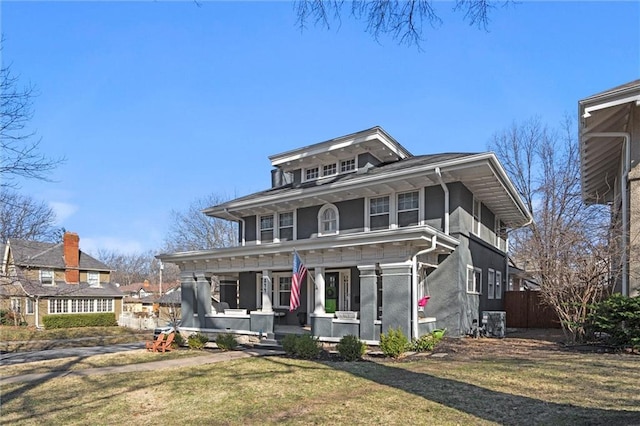 traditional style home with a front yard, central air condition unit, covered porch, and stucco siding