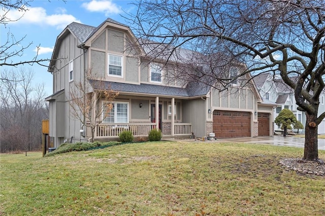 view of front of house featuring a garage, driveway, covered porch, and a front yard