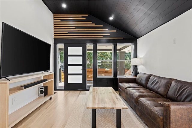 living area featuring lofted ceiling, wooden ceiling, plenty of natural light, and wood finished floors