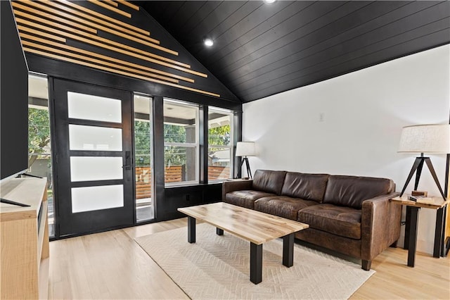 living area featuring vaulted ceiling, wooden ceiling, and wood finished floors