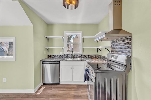 kitchen with open shelves, a sink, white cabinets, appliances with stainless steel finishes, and island range hood