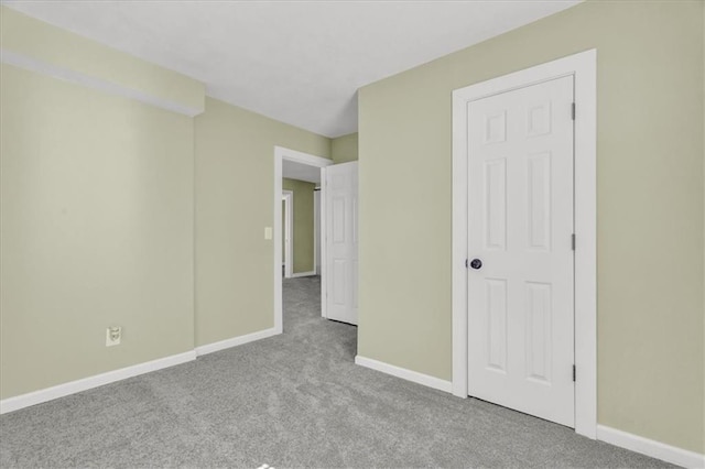 unfurnished bedroom with baseboards and carpet