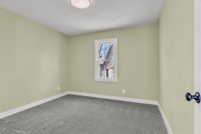 carpeted spare room with baseboards