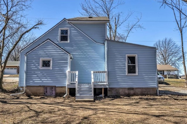 back of property featuring a wooden deck and fence