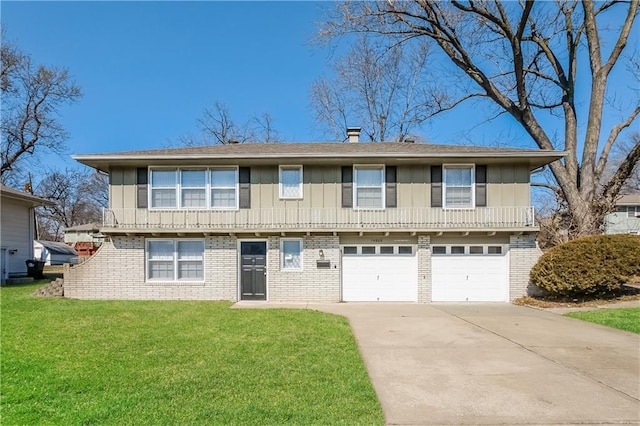 view of front of property featuring board and batten siding, a front yard, brick siding, and driveway