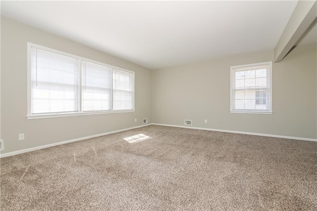 carpeted spare room with baseboards