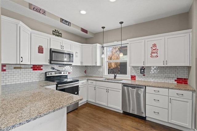 kitchen featuring dark wood-style flooring, white cabinets, appliances with stainless steel finishes, and a sink